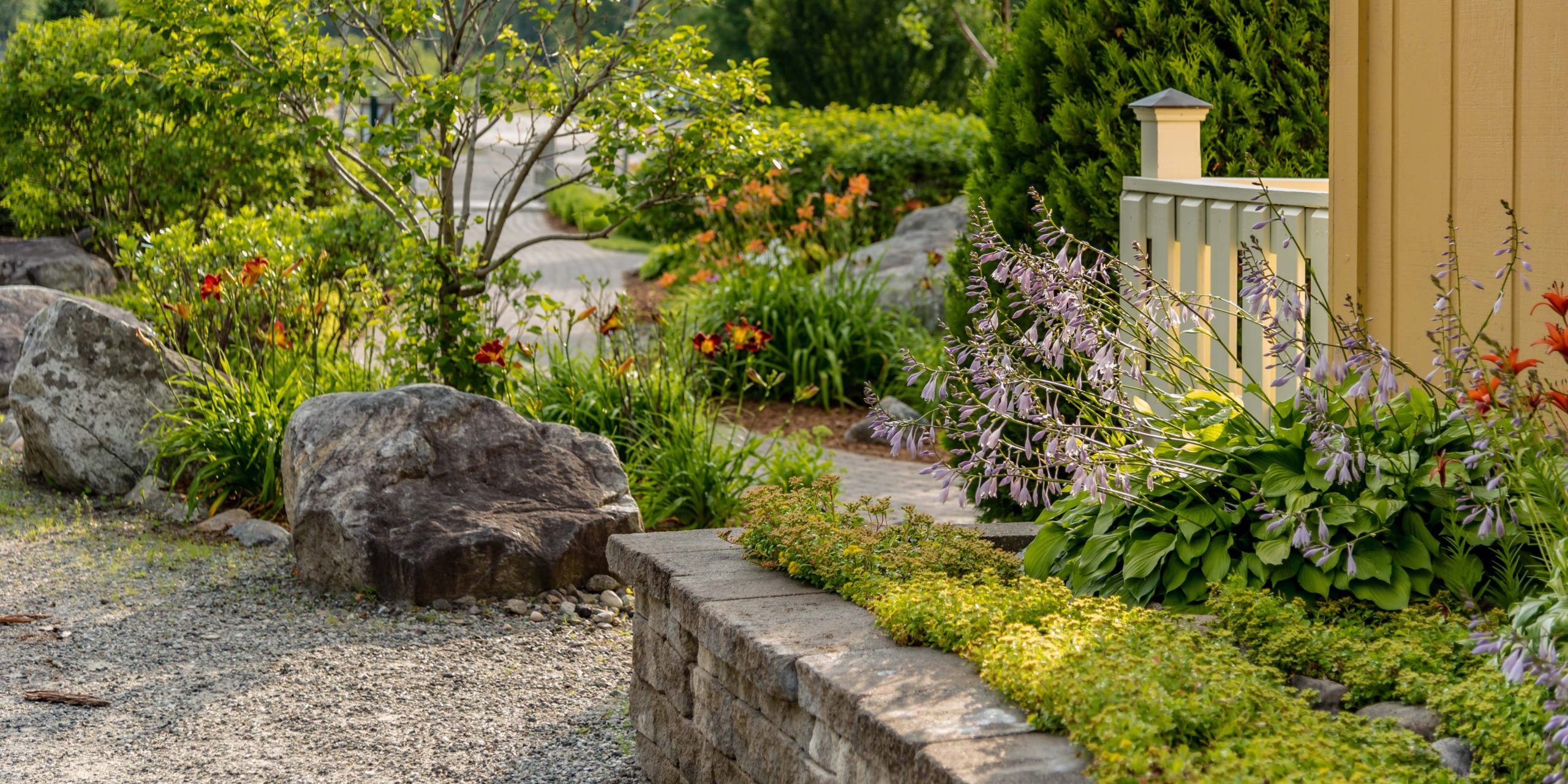 stone wall with landscaping and decorative rocks